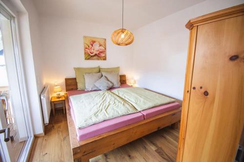 a bedroom with a bed and a pendant light at Rotmilanblick in Bischofsheim an der Rhön
