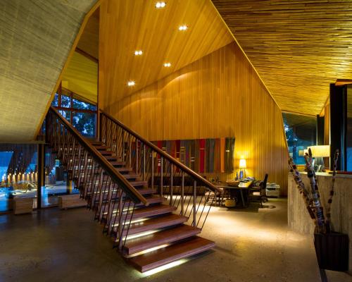a staircase in a room with a wooden wall at Refugia Chiloé in San José