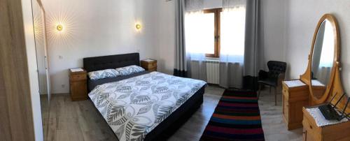 a bedroom with a bed and a mirror at Old City Hill in Sarajevo