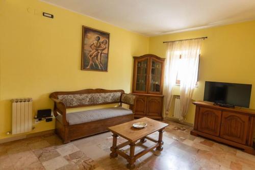 a living room with a couch and a table at Caldora Apartment in LʼAquila