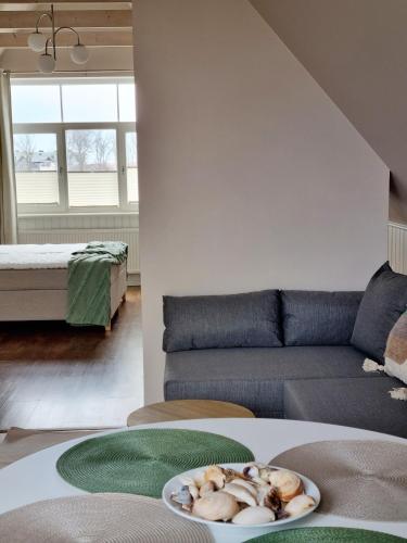 a living room with a couch and a plate on a table at Villa Marienholm in Haapsalu