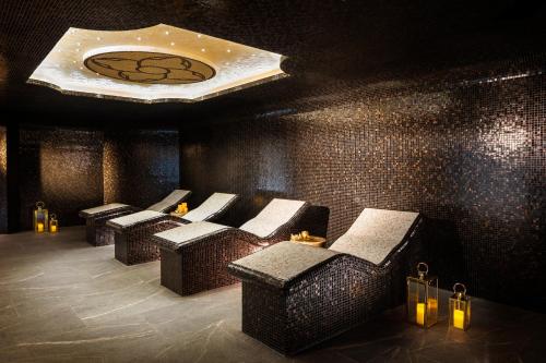 a row of chairs in a room with a ceiling at Kings' Valley Medical & Spa Hotel in Kazanlŭk