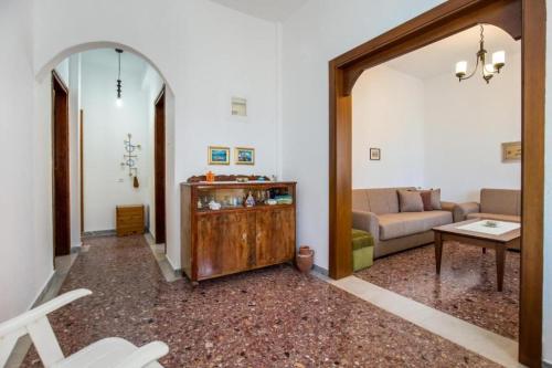 a living room with a couch and a table at Xanthi's Dream Place in Potos