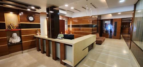 a lobby with a desk with a laptop on it at Hotel Kanak in Ahmedabad