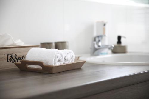 a bathroom with a sink and towels on a counter at Palais Passy~Design Suite mit Ausblick im Zentrum in Wiesbaden