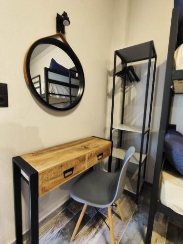 a desk with a chair and a mirror on a wall at Grecos STAY SKIATHOS in Skiathos Town