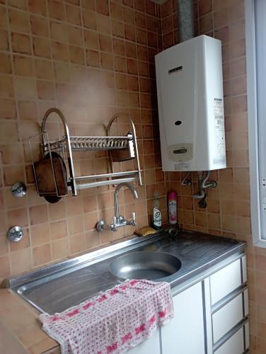 a kitchen counter with a sink and a coffee maker at San Cayetano in San Salvador de Jujuy