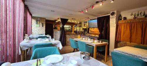 a restaurant with two tables and blue chairs at Bed & Breakfast Villa Adriana in Premantura