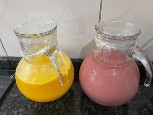a blender and a jug of orange juice on a counter at Hotel Carrão in Sao Paulo