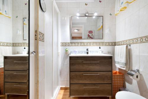 a bathroom with a sink and a mirror at Jolly suite puertorico Beach in Mogán