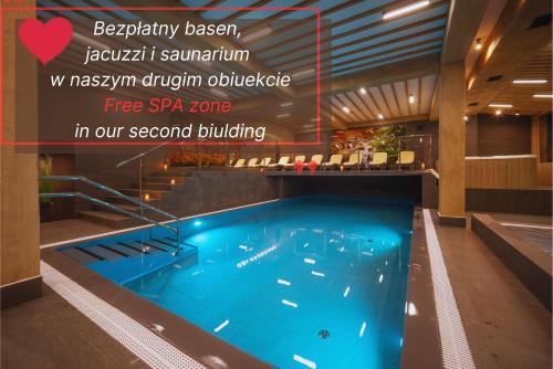 ザコパネにあるWilla Kocham Tatryの2つ目の建物内のスパゾーンを読み取る標識付きのホテル内のプール