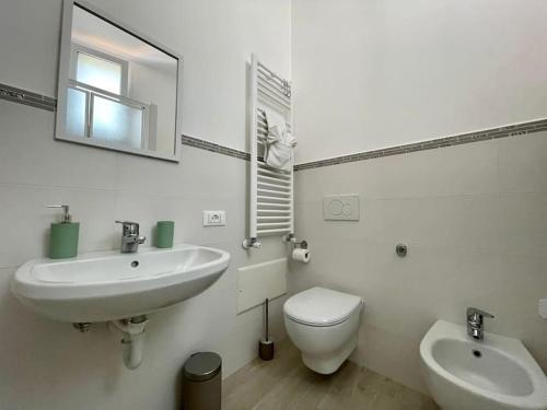 a bathroom with a sink and a toilet and a mirror at Casa in centro Ischia Porto Forever Four in Ischia