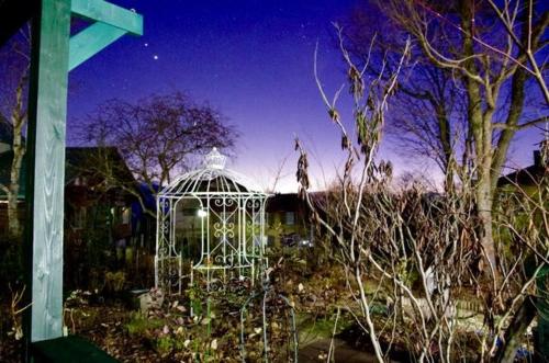 a white gazebo in the middle of a garden at Gallery HARA and guest house in Hara