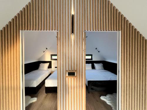 two mirrors in a room with two beds at Domki Grabina 