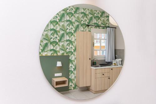 a bathroom with a mirror on a wall at Sunshine Studios in Malia