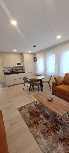 a living room with a couch and a table at Apartamentos La Quinta in Burgos