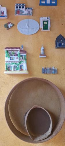 a wall with a house and other objects on it at O Cantinho Alojamento Local in Luso