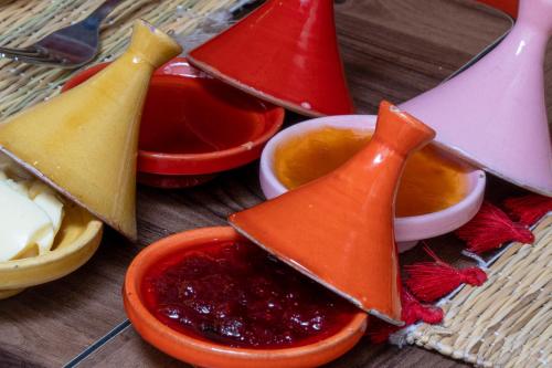a wooden table with three different types of food at Riad Le Plein Sud in Marrakech