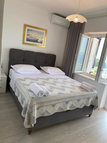 a bedroom with a large bed with towels on it at House Bartulović in Brela