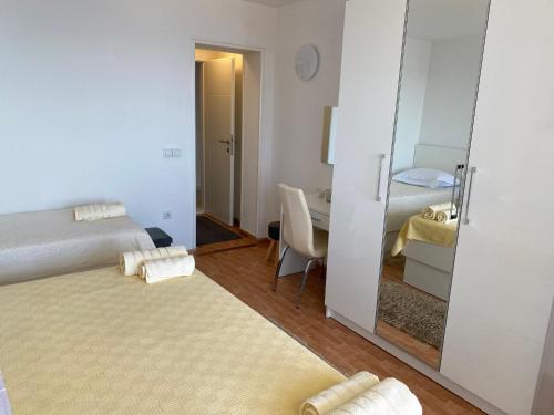 a bedroom with a mirror and a bed and a desk at House Bartulović in Brela