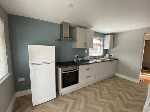 a kitchen with a white refrigerator and a stove at Luxury holiday rental with sea views on the Wild Atlantic Way in Tralee