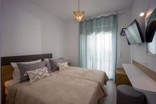 a bedroom with a bed and a window at Hermagio Villa Hermione by Estia in Malia