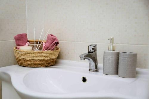 a bathroom sink with a basket on top of it at The Wave in Tivat