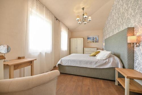 a bedroom with a bed and a couch and a chair at Luxury Villa Solea in Barušić