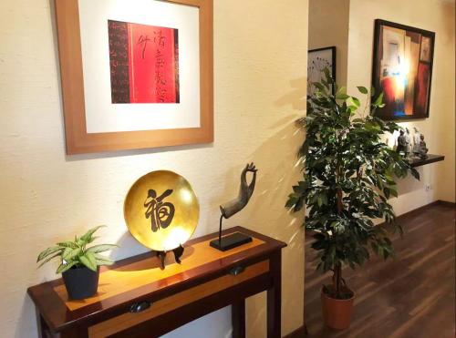 a room with a table with a mirror and a plant at Room in a nice and cosy place in Mondorf in Mondorf-les-Bains