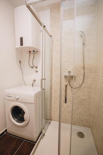 a washing machine in a bathroom with a shower at Status-M Apartments 112 in Bečići