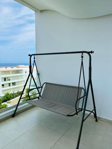 a swing on the balcony of a building at Lujoso aprtamento cap tingis playa tanger in Tangier