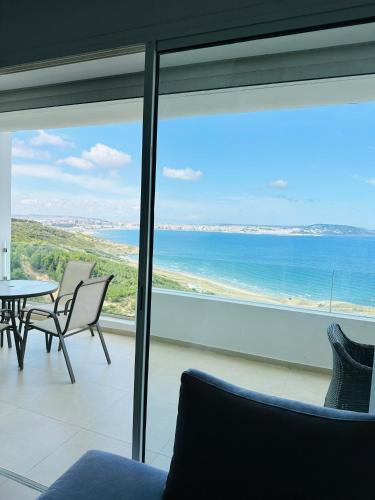 a living room with a view of the ocean at Lujoso aprtamento cap tingis playa tanger in Tangier
