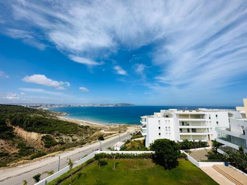 a view of the ocean from a building at Lujoso aprtamento cap tingis playa tanger in Tangier