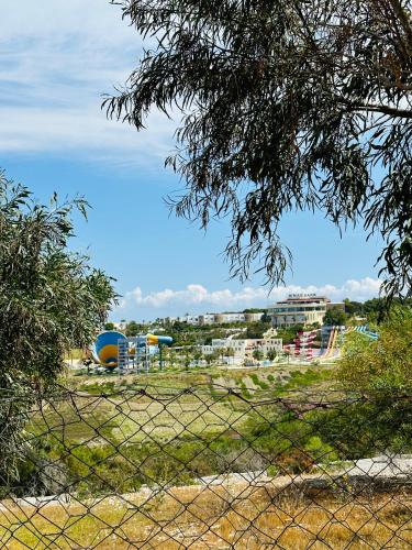 a view of a playground behind a fence at Lujoso aprtamento cap tingis playa tanger in Tangier