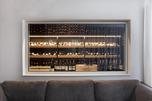 a room with a large display case of wine bottles at Hotel Shuum Boutique - Destigo Hotels in Kołobrzeg