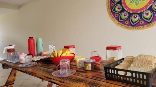 a wooden table with a bunch of food on it at Mandallah Hostel in Joinville