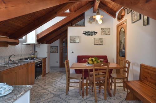 a kitchen with a table with a bowl of fruit on it at Luna Rossa in Minori