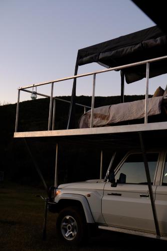 a white truck with a bunk bed on top of it at Dream Cruiser in Addo with Private Bath in Kirkwood