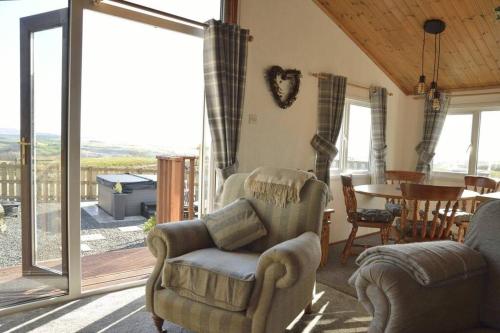 a living room with a couch and chairs and a table at Lochhill Stable Lodge in Castle Douglas
