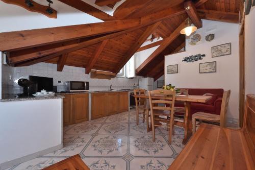 a kitchen with wooden cabinets and a table and chairs at Luna Rossa in Minori