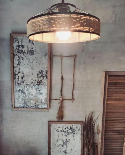 a light hanging from a ceiling in a room at Prana Siargao Resort in General Luna