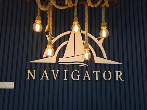 a chandelier with the name of a naveder hanging at Navigator in Palić