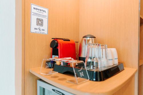 a kitchen counter with a coffee maker on a shelf at Novotel Trabzon in Trabzon