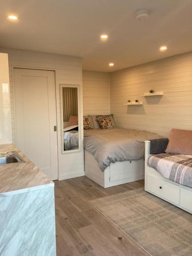 a bedroom with two beds and a mirror at Donegal Luxury Pods in Gweedore