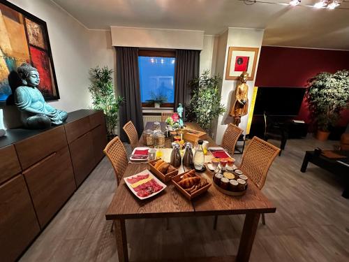 a living room with a table with food on it at Room in a nice and cosy place in Mondorf in Mondorf-les-Bains