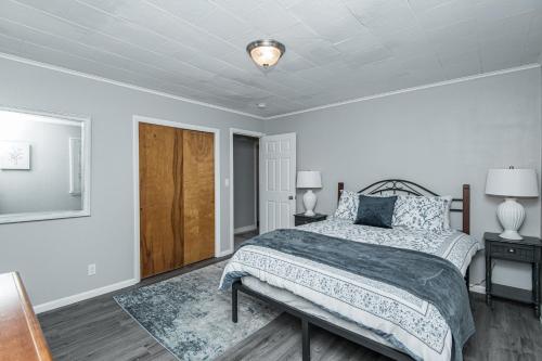 a bedroom with a bed and two night stands and two lamps at 3 bedroom showstopper near Mayo Clinic in Rochester