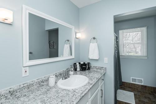a bathroom with a sink and a mirror at 3 bedroom showstopper near Mayo Clinic in Rochester