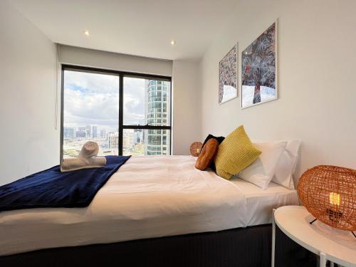 1 dormitorio con 1 cama grande y ventana grande en Astonishing Southbank Pearl Tower Residences near Crown Casino, en Melbourne