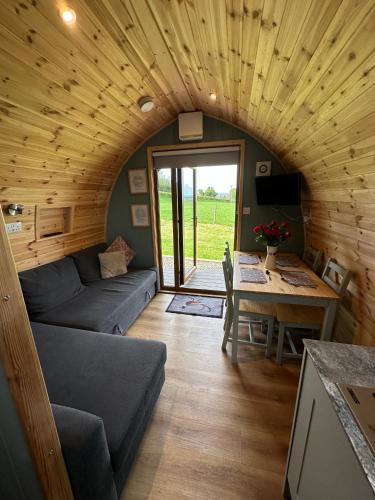 a living room with a couch and a table at West Wood Yurts Ltd in Newcastle upon Tyne