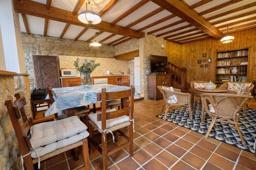 a kitchen with a table and chairs in a room at Casona del Sol El Retorno I in Lastres